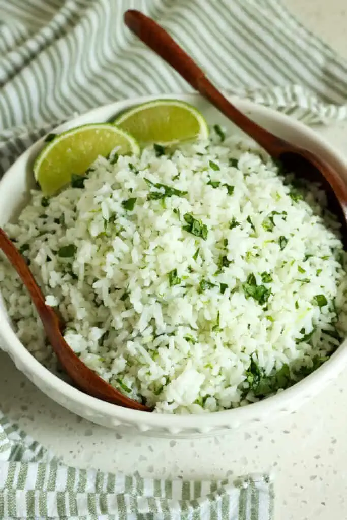 This quick and easy copycat Cilantro Lime Rice is made with eight easy ingredients, and it is the perfect side dish for all your favorite Mexican and Cuban recipes.