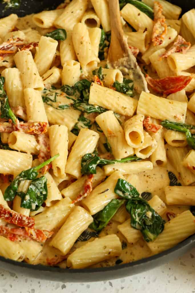 A quick and tasty Sun-dried Tomato Pasta recipe with garlic and spinach in a creamy parmesan cheese sauce. Serve as a main course vegetarian dish or as a side for beef, chicken, pork, or fish. 