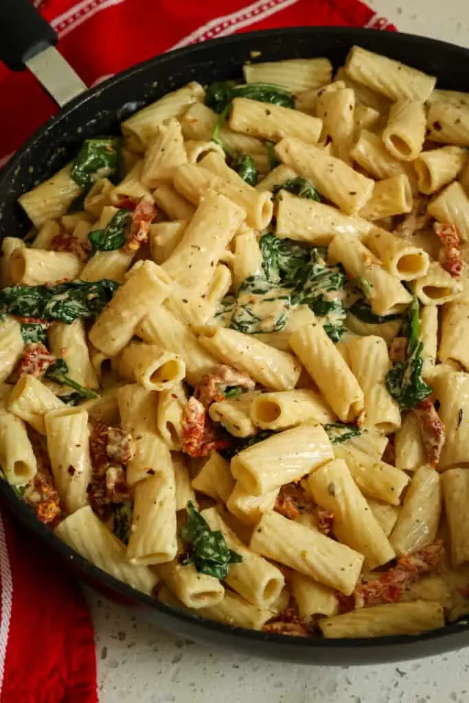 Add the cooked and drained pasta to the skillet and stir to coat. Season with red pepper flakes, kosher salt, and fresh ground black pepper to taste. 