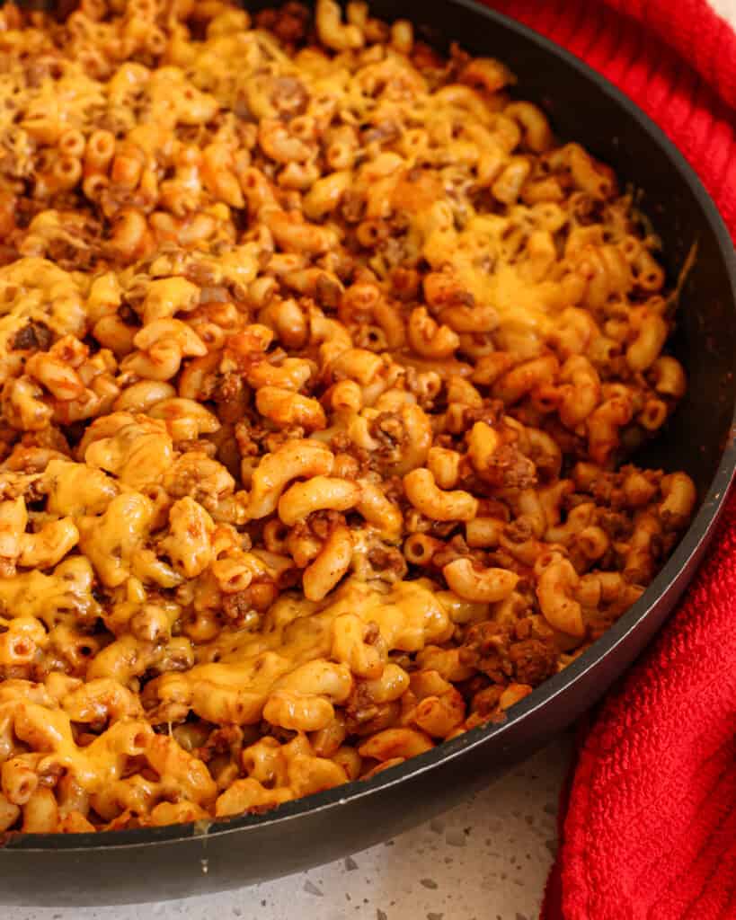 Beefaroni is a tasty combination of browned ground beef, onion, garlic, and macaroni noodles in a tomato base seasoned with paprika and chili powder, all smothered in melted cheddar cheese. 