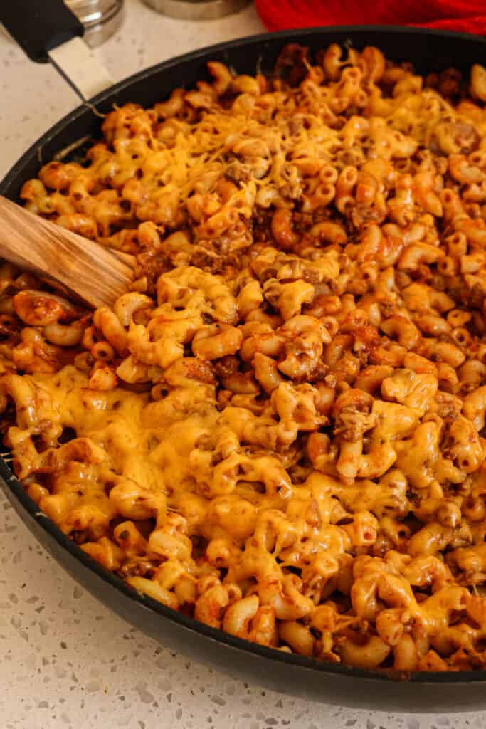 A quick and tasty Beefaroni recipe made with ground beef, elbow macaroni, onion, garlic, and a few common pantry spices in a tomato base, all topped with melted sharp cheddar. 