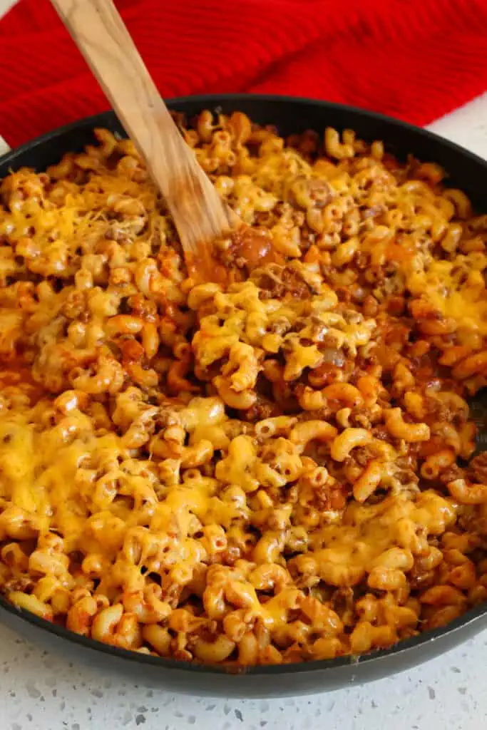 Beefaroni is a tasty combination of browned ground beef, onion, garlic, and macaroni noodles in a tomato base seasoned with paprika and chili powder, all smothered in melted cheddar cheese.