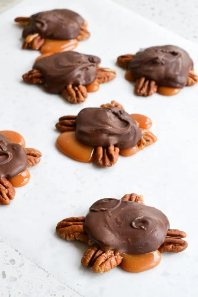 Delicious Homemade Turtles candies are made super easy using microwave caramel.  Perfect for parties, holiday gift giving, and hostess presents.