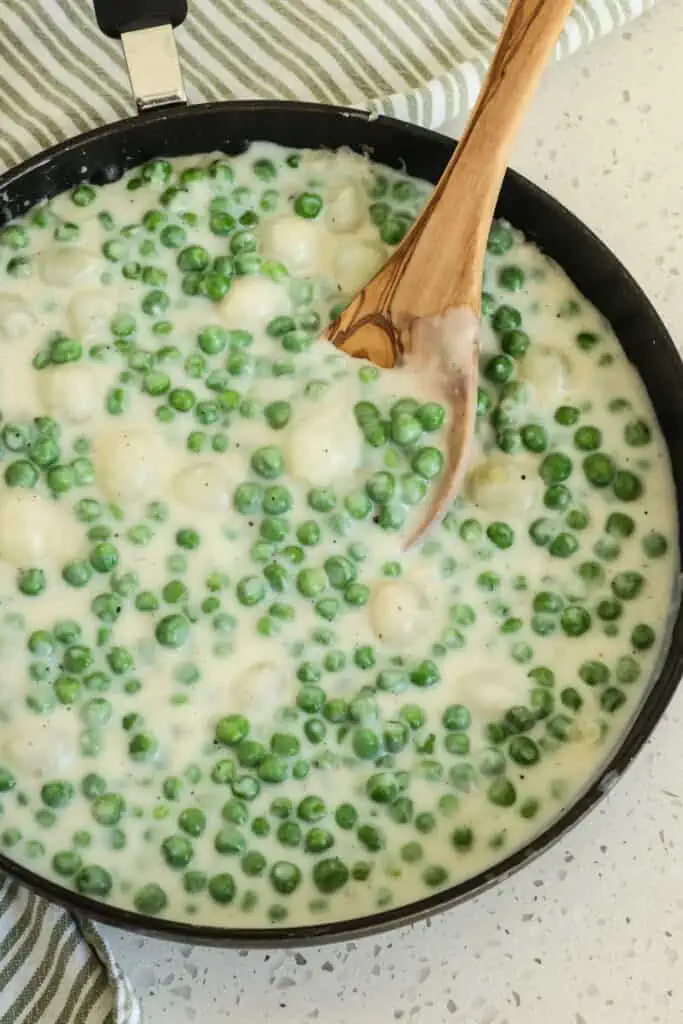 Creamed peas and pearl onions are combined in an easy-to-make rich, creamy white sauce.  They are a delectable side for steak, chicken, and beef or spooned over mashed or baked potatoes.