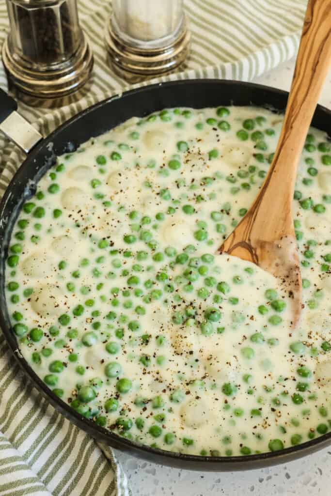 These sweet Creamed Peas with Pearl Onions combine peas and pearl onions with a luscious cream sauce, made easily with a roux, into the best side dish ever. 