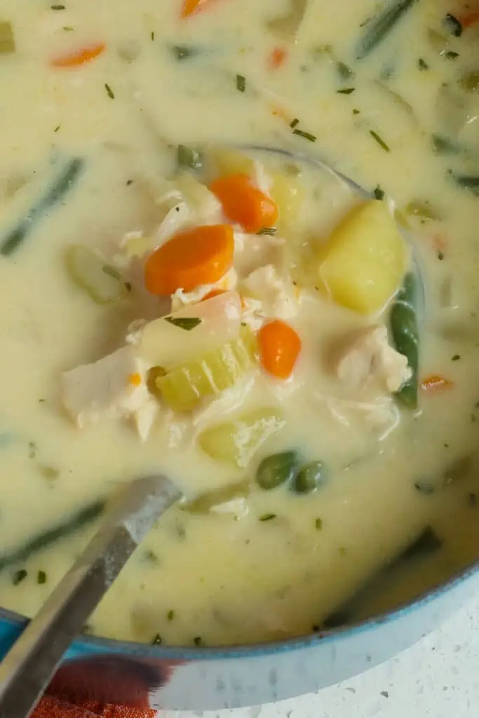 A delicious Chicken soup with onion, celery, carrots, potatoes, and green beans in a perfectly seasoned creamy broth.