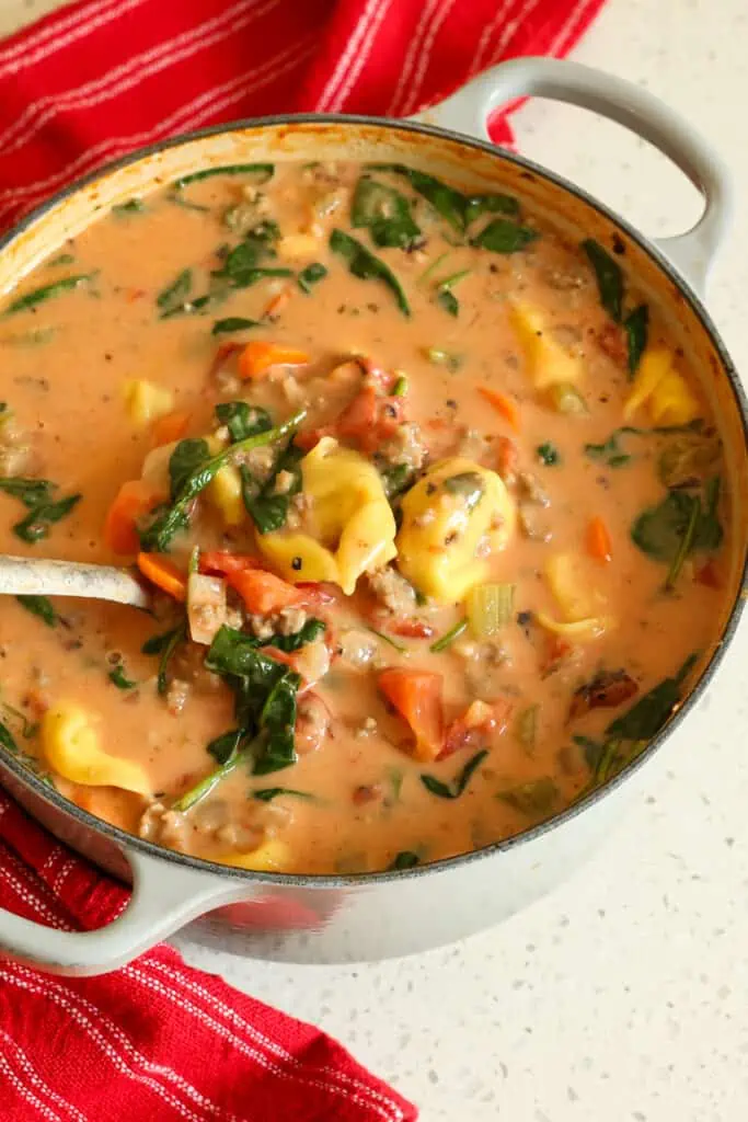 Creamy Tortellini Soup is pure heavenly comfort with Italian sausage, vegetables, tomatoes, and cheese tortellini in a creamy tomato base, seasoned with Italian herbs and fresh Parmesan Cheese. 