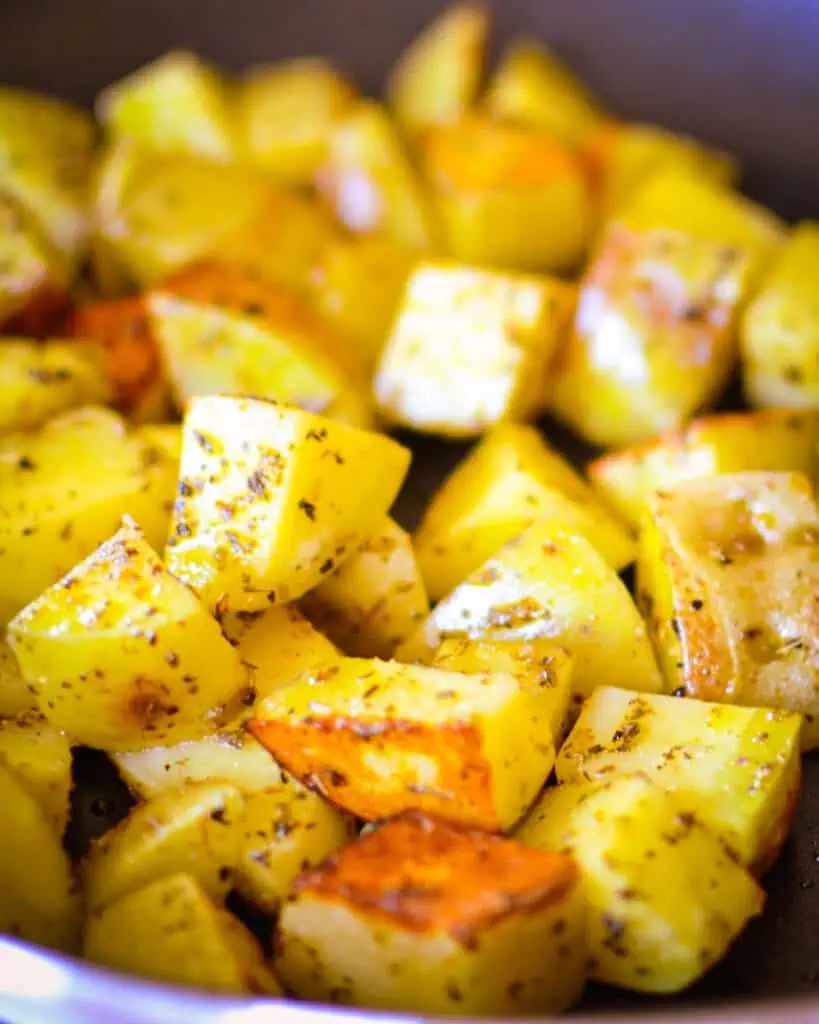 Heat a large nonstick skillet over medium-high heat and add potatoes.  Cook until the potatoes start to brown, stirring occasionally. 