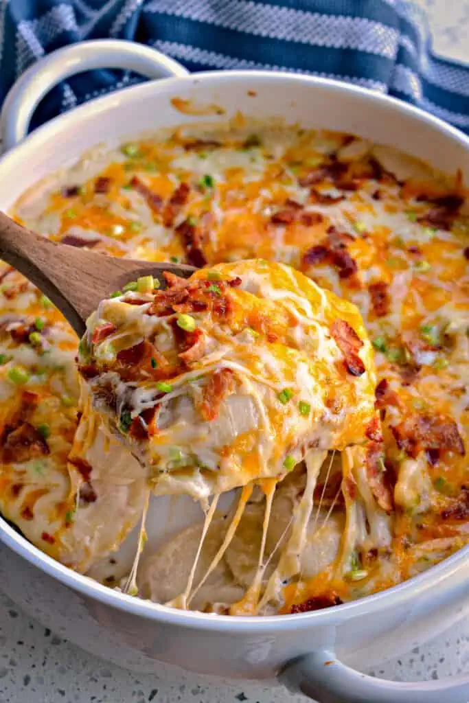This Cheesy Pierogi Casserole is layered with alfredo sauce, green onions, bacon and shredded mozzarella and cheddar cheese. 