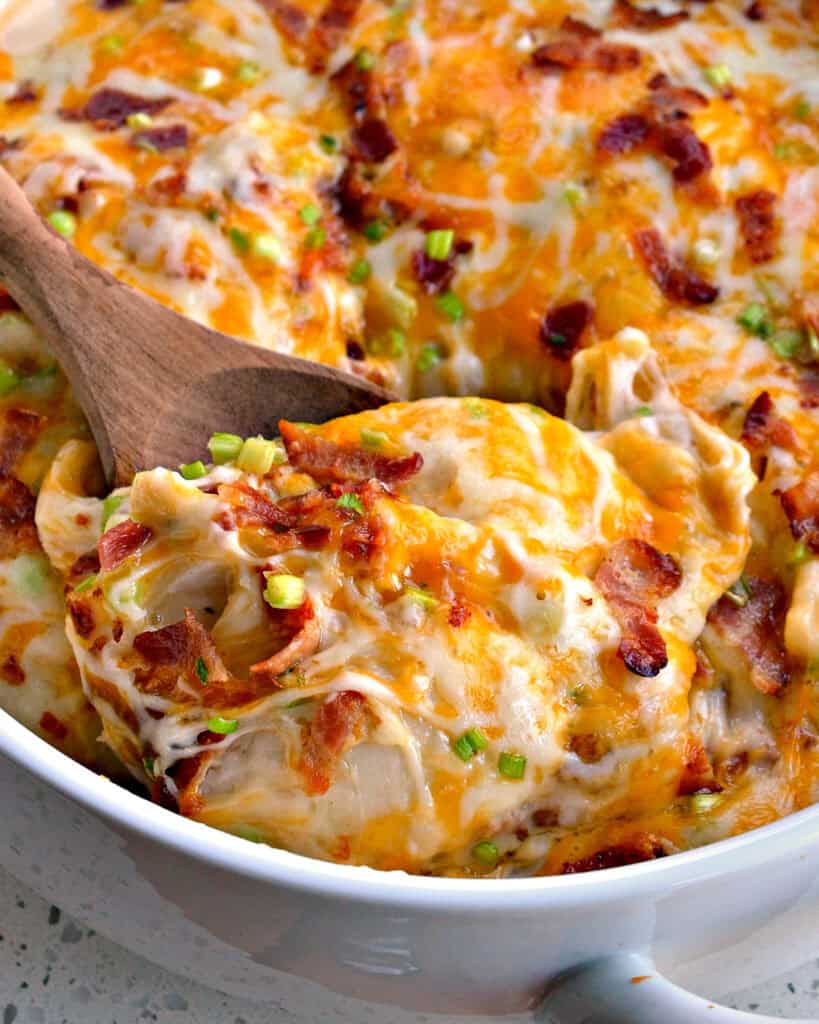 A wooden spoon full of pierogi casserole.