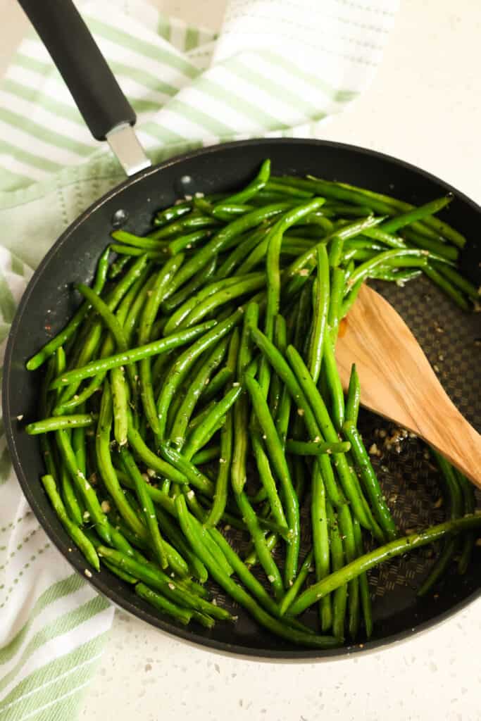Perfectly seasoned easy Sautéed Green Beans are made in about ten minutes in a large skillet right on the stovetop.