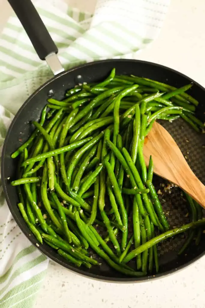 Perfectly seasoned easy Sautéed Green Beans are made in about ten minutes in a large skillet right on the stovetop. 
