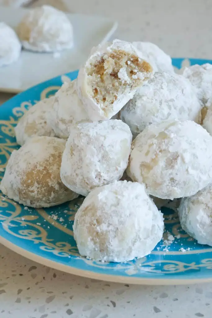 These classic Snowball Cookies are little balls of buttery shortbread melt-in-your-mouth goodness with a powdered sugar coating. 