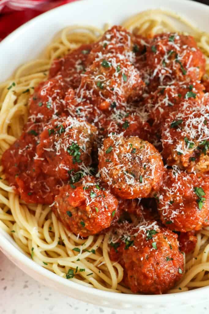 This tasty Spaghetti and Meatballs recipe brings homemade tender and juicy browned meatballs together with a simple six-ingredient marinara that is much better than jarred sauce.