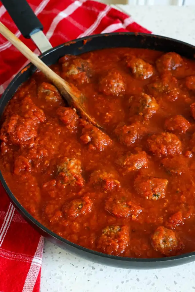 Add the baked meatballs to the marinara sauce, stir gently to combine, simmer for 5 minutes.