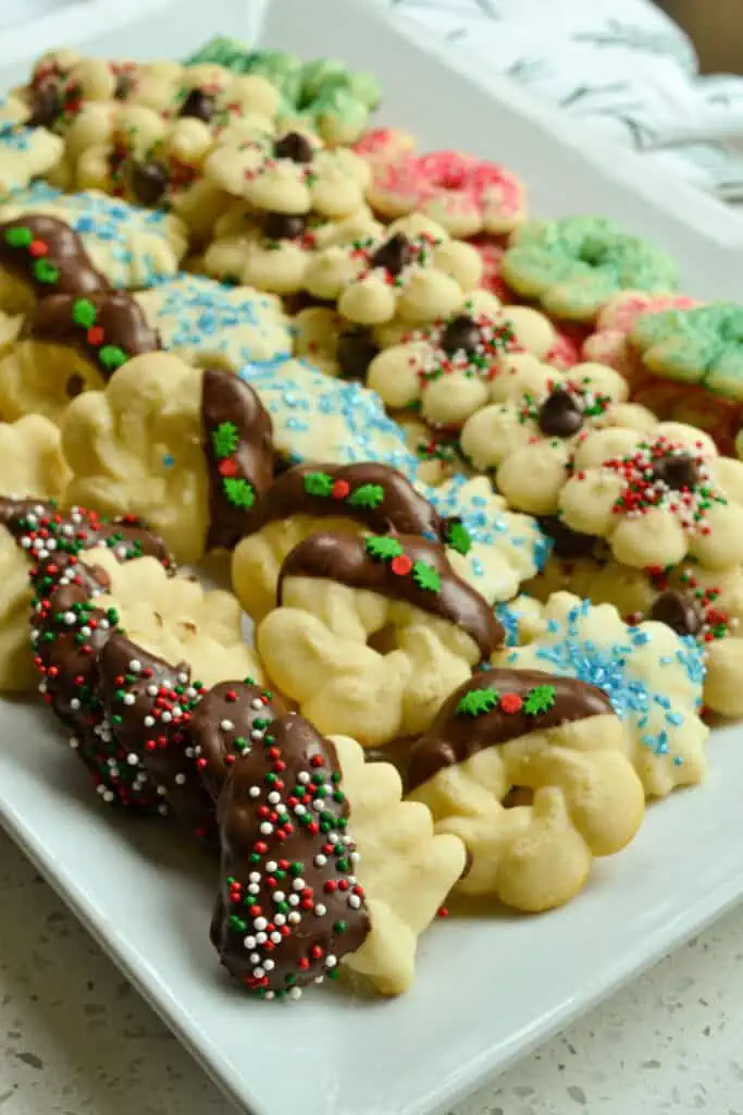 These melt in your mouth adorable little buttery Spritz Cookies are made easy with seven ingredients in a cookie press.