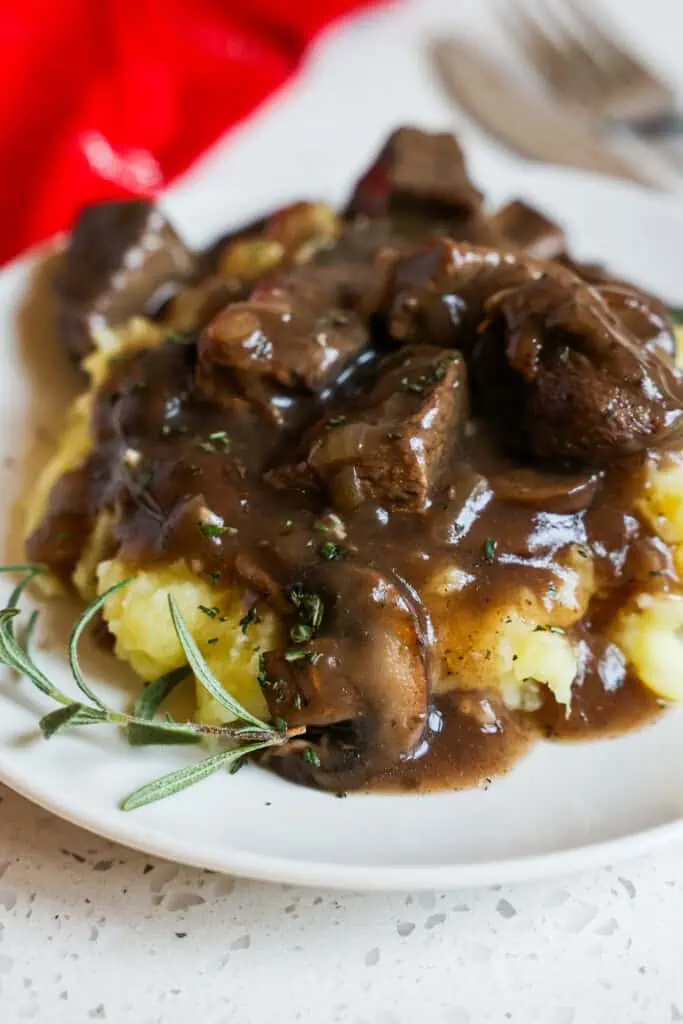 Beef Tips and Gravy combines tender beef chunks, mushrooms, onions, and garlic in a rich and smooth brown gravy that is lightly seasoned. 