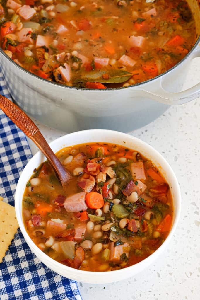 This Cajun-style Black Eyed Pea Soup is loaded with flavor from bacon, ham, fresh garden vegetables, tomatoes, and collard greens in a simple broth with Cajun seasoning and thyme. 