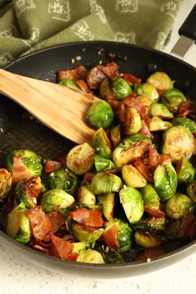 This quick and easy Brussels sprouts recipe combines pan-sauteed Brussels sprouts with crispy bacon, garlic, and a drizzle of maple syrup.