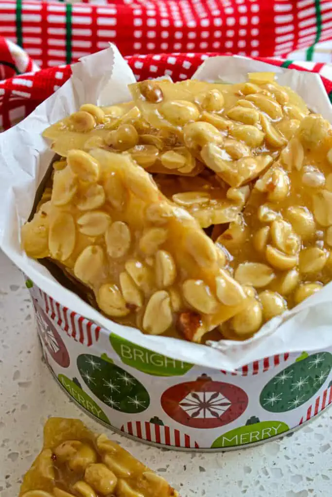 A Christmas tin full of homemade peanut brittle. 
