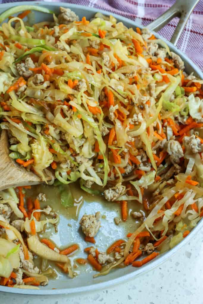 A quick and healthy Cabbage Stir Fry Recipe made with ground turkey or ground chicken, onions, cabbage, carrots, ginger, and garlic all in a sweet and savory sauce.