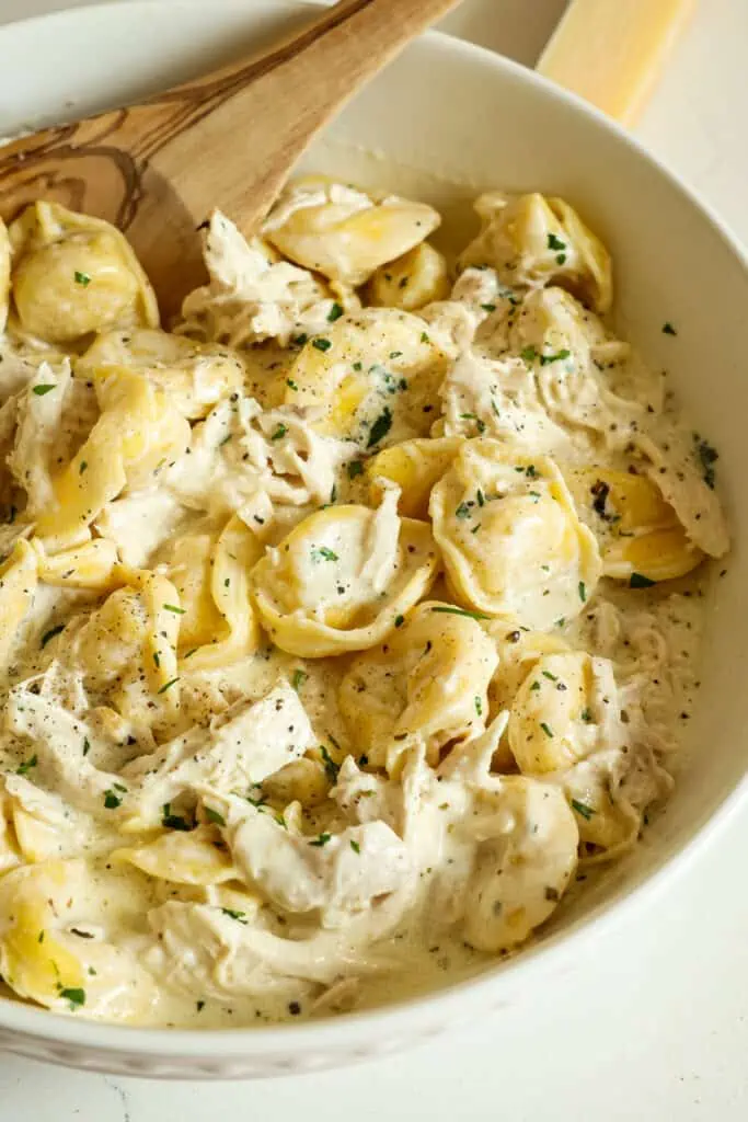 This amazing Chicken Tortellini Alfredo combines succulent rotisserie chicken with refrigerator or frozen cheese tortellini in a rich and creamy five-ingredient homemade alfredo sauce.