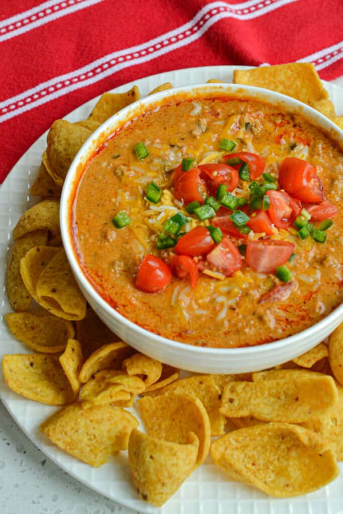 Chili Cheese Dip is a blend of thick chili. salsa style tomatoes, cream cheese, hot sauce, cheddar and Pepper Jack cheese.
