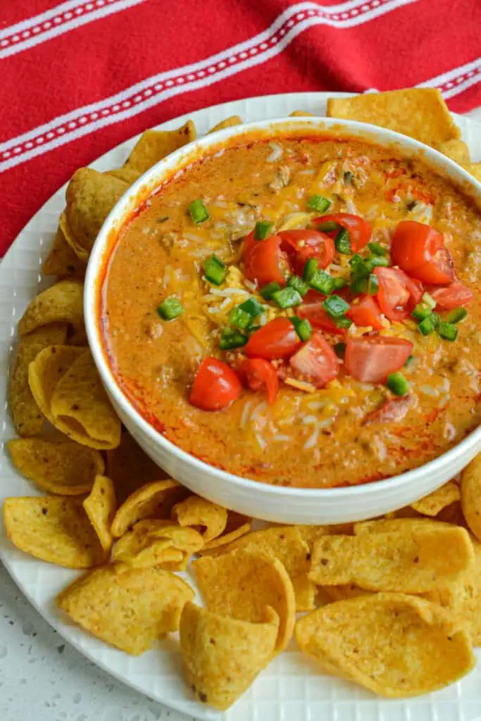 Chili Cheese Dip is a blend of thick chili. salsa style tomatoes, cream cheese, hot sauce, cheddar and Pepper Jack cheese. 