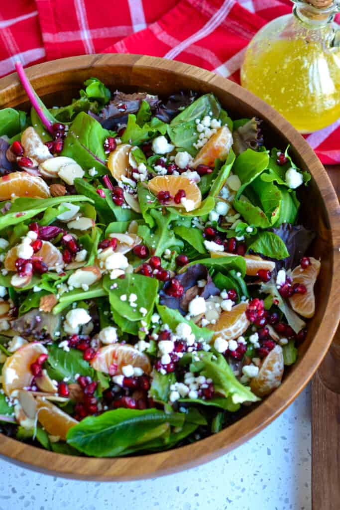 Topped with mandarin oranges, pomegranate seeds, and feta cheese, this Christmas salad is a sweet, refreshing side salad.