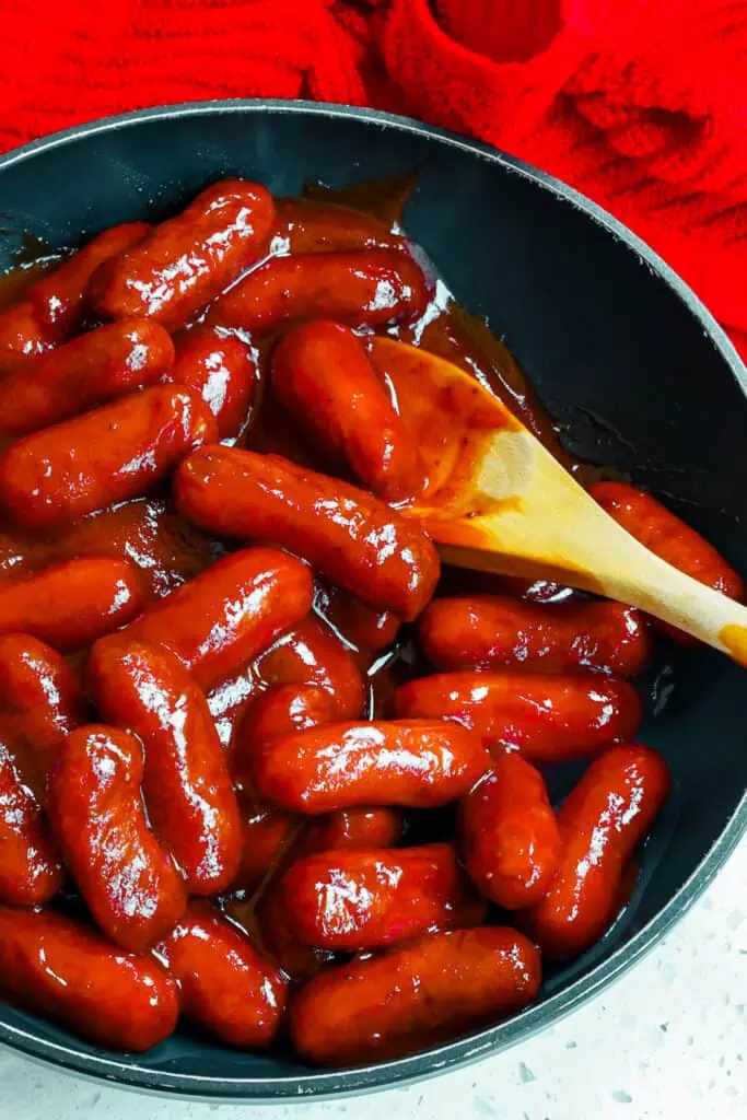 Add the little smokies to a skillet.  Add the rest of the ingredients and stir to combine.  Cook over low heat until the little smokies are glazed and warmed through or for about 20 minutes.