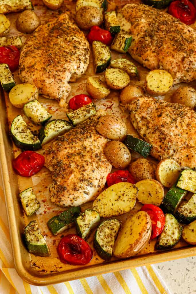 This sheet pan Italian Chicken is tender marinated chicken breasts and garden fresh vegetables seasoned and roasted to perfection. It is a quick and easy dinner that the whole family enjoys!  
