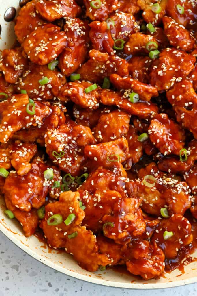 This easy Sesame Chicken Recipe combines pieces of battered crispy fried chicken with an easy eight-ingredient sauce that has both sweet and salty flavors with just a hint of spice.