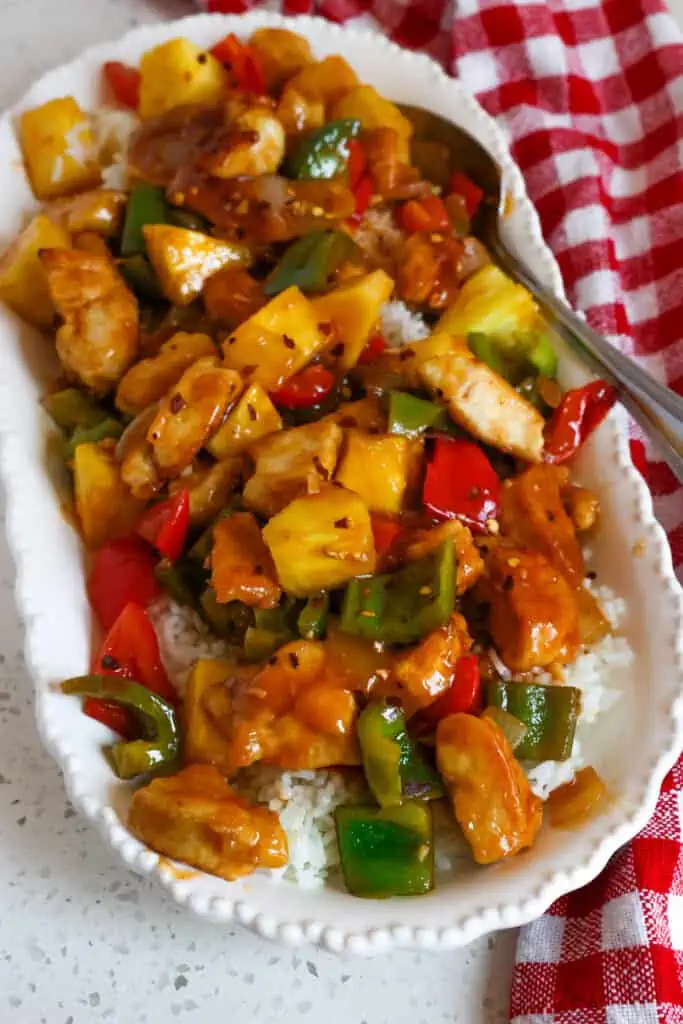This one skillet Sweet and Sour Chicken Recipe brings crunchy pan-fried chicken together with sweet bell peppers and pineapple chunks in a lightly sweetened sauce.