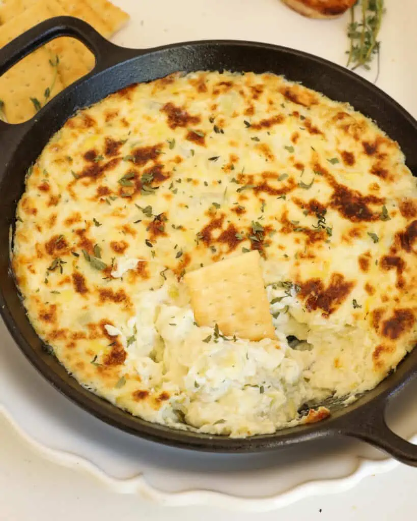 Impress your guests with this deliciously creamy baked artichoke dip.