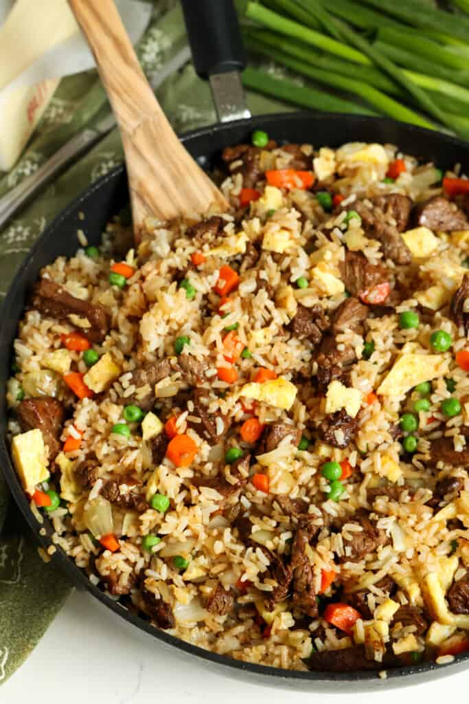 This Beef Fried Rice is loaded with tender stir-fried marinated steak, eggs, veggies, and fried rice, all in a sweet and savory ginger sauce. 