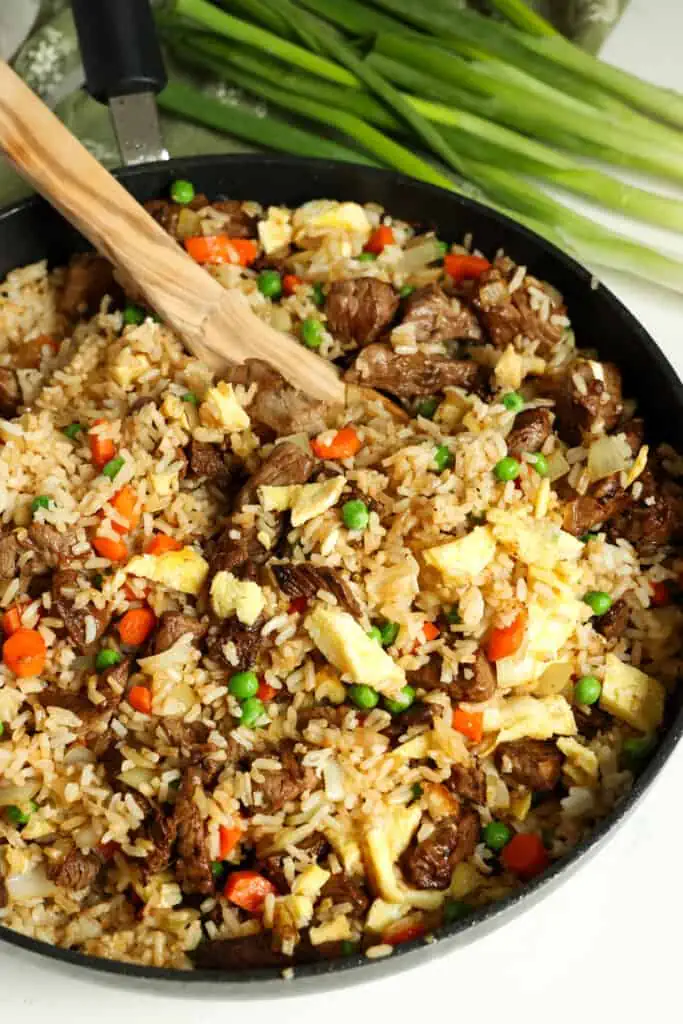 This Beef Fried Rice is loaded with tender stir-fried marinated steak, eggs, veggies, and fried rice, all in a sweet and savory ginger sauce.