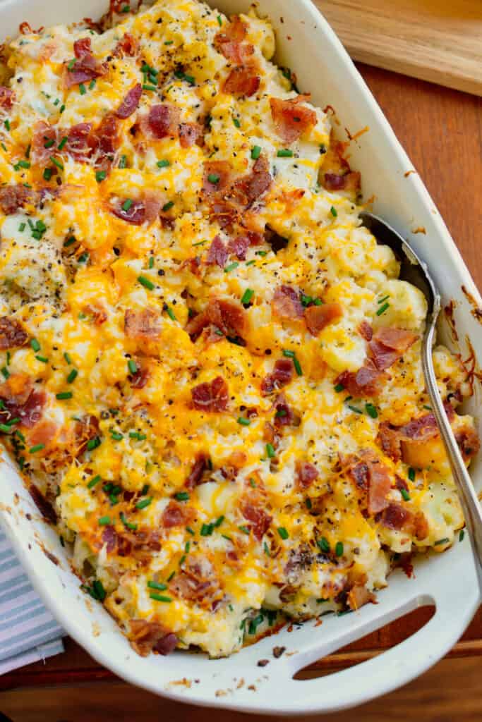 Loaded Cauliflower Casserole is steamed cauliflower combined with cream cheese, sour cream, sharp cheddar, Monterey Jack, bacon, and chives. 
