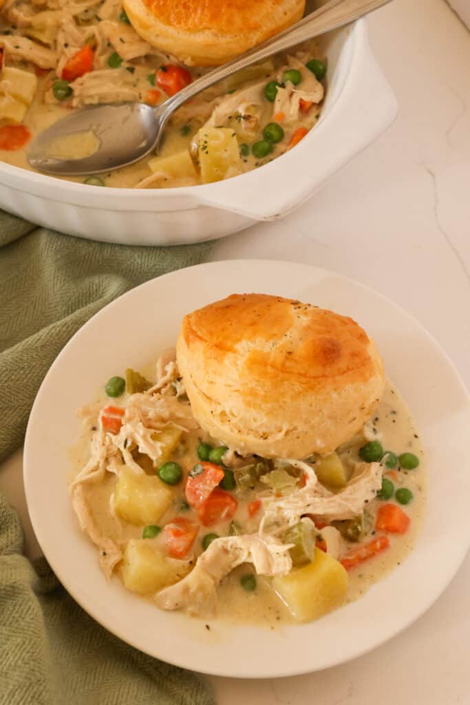 This comforting casserole features a creamy chicken and vegetable filling topped with buttery and flaky biscuits. The ultimate comfort food recipe. 