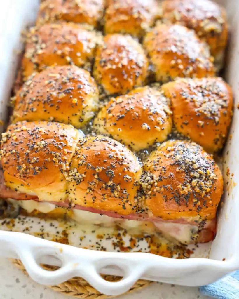Quick and easy Ham and Cheese Sliders baked with a generous helping of honey butter seasoned with minced onion, poppy seeds, and Dijon mustard. 