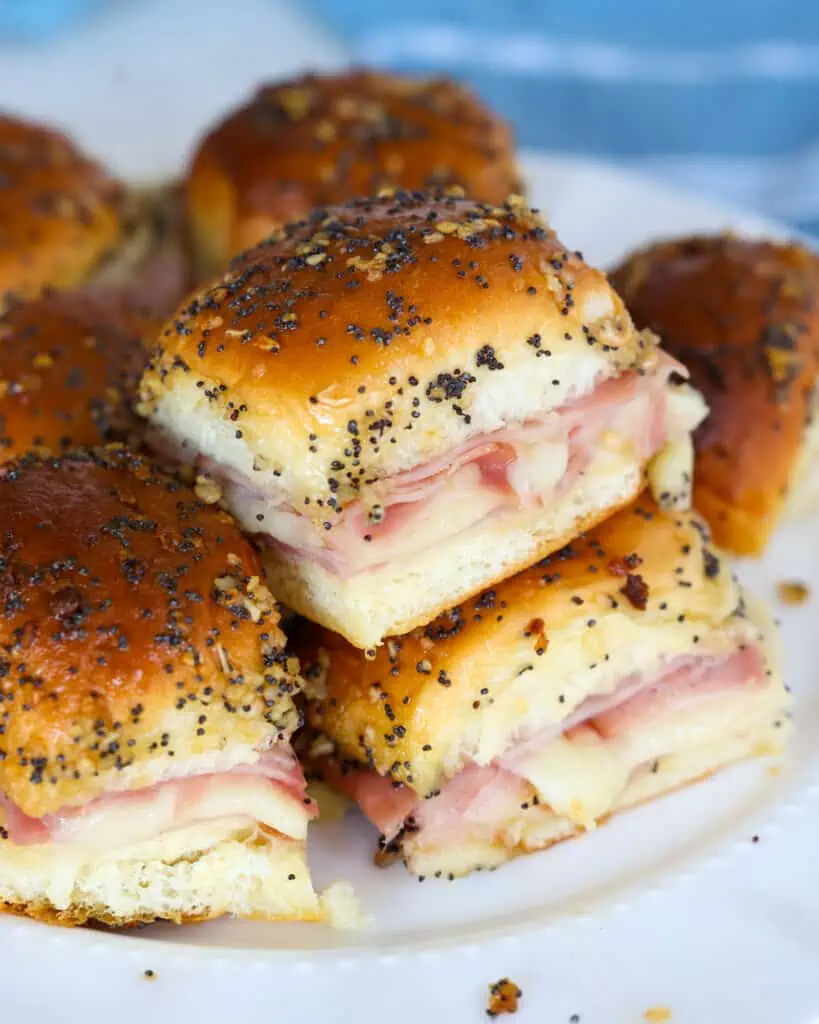 Party-worthy and delectable Ham and Cheese Sliders recipe made with Hawaiian Sweet Rolls, smoked honey ham, and Swiss Cheese, all slathered with a Dijon mustard poppy seed butter.