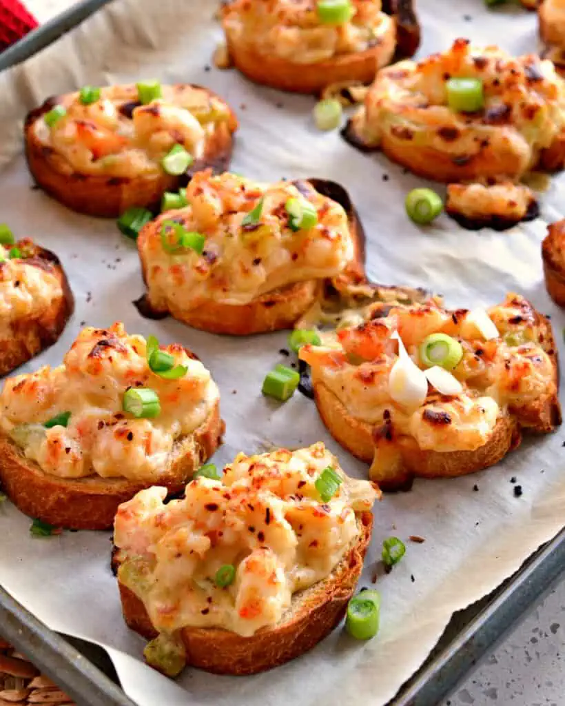 Shrimp toasts are fresh chopped shrimp, onion, celery, and garlic, all nested in a luscious sauce made from cream cheese, Parmesan, and Fontina cheese with just a hint of Cajun spice.