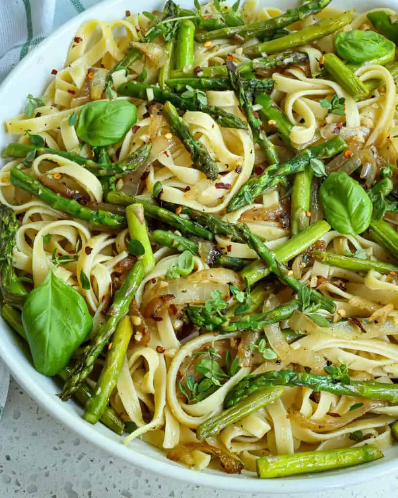 A quick and easy light Asparagus Pasta with grated Parmesan Cheese, fresh herbs, and lemon zest.  It is the perfect accompaniment for all your summer grilling. 