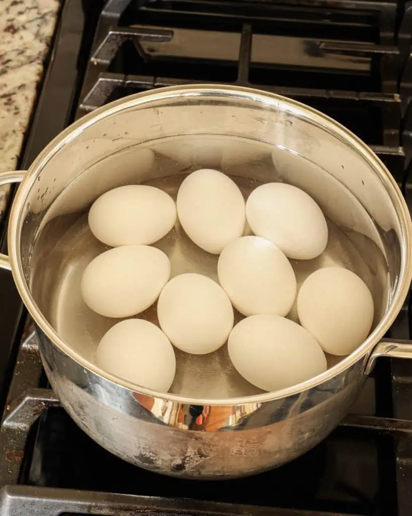 Add the eggs to a large pot without overcrowding. Fill the pot with cold water to an inch over the eggs,  