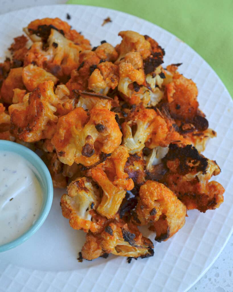 These delicious and easy-baked Buffalo Cauliflower wings are just as good as buffalo wings, with a lot less calories and fat.  Bake up a batch for game day or movie night.