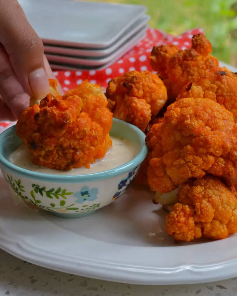 These Buffalo Cauliflower bites are baked bite-size pieces of crispy cauliflower that are slathered with buttery buffalo sauce and broiled to golden crispy perfection.