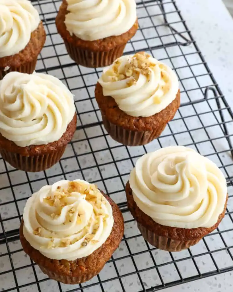 Carrot cupcakes are one of my most requested potluck recipes and are perfect for parties, shindigs, bridal showers, and baby showers.