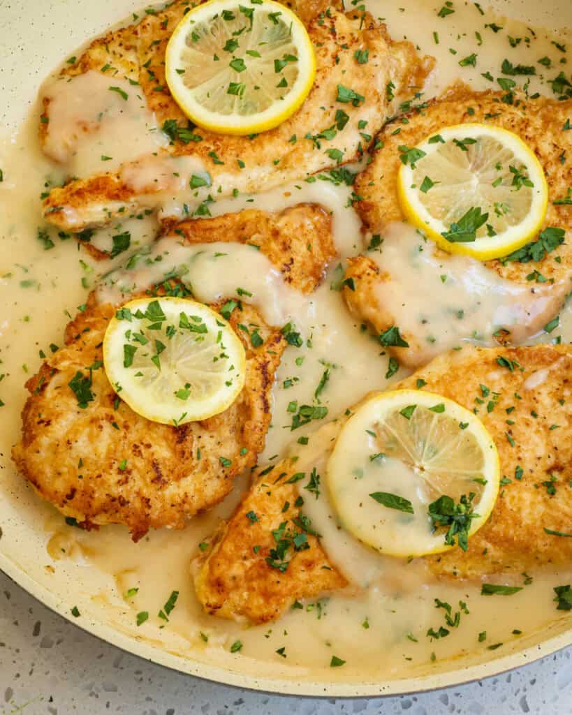 Chicken frances with lemon sauce in a large skillet.