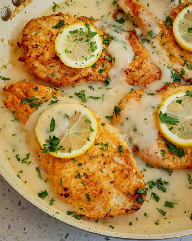 Delicious Italian American Chicken Francese with chicken cutlets dredged in flour, dipped in beaten eggs, and pan fried crisp and served in a lemon white wine sauce. 