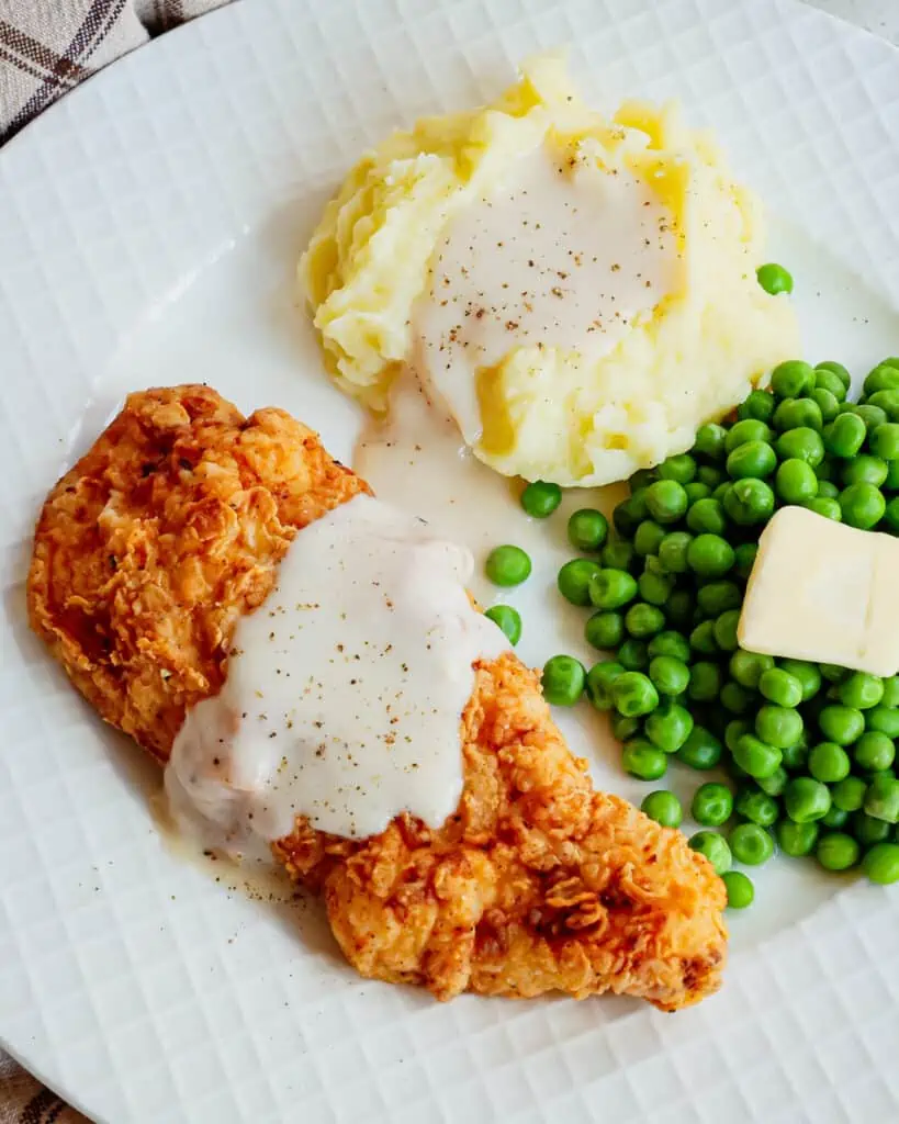 I love to serve Chicken Fried Chicken with creamy mashed potatoes and fresh green beans or baby peas.