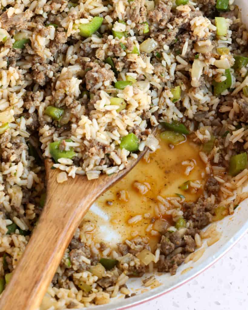 Flavorful New Orleans-style Dirty Rice with browned ground beef, pork sausage, onions, celery, green peppers, chicken livers, garlic, Cajun seasoning, and rice.